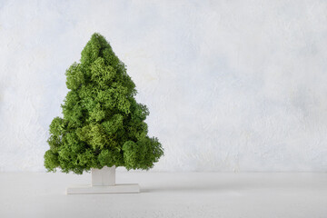 Creative alternative Christmas tree decorated green moss on white blue background. DIY. Concept eco friendly Xmas holiday. Zero waste.