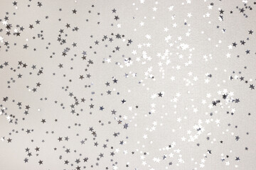 Metallic silver colored stars confetti. Monochrome festive concept.