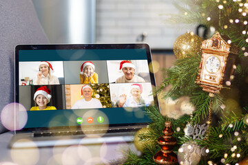 laptop with gift box and christmas lights background.