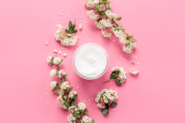 White moisturizing cream cosmetic for spa treatment with blossoms flowers
