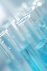 Laboratory test tubes with blue liquid close up, selective focus. Scientific laboratory research and experiments