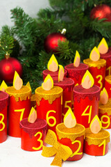 Handmade advent calendar with toilet paper tubes. Christmas candle craft. Seasonal activity for kids. Reuse concept