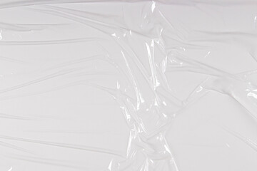 Transparent film cellophane background. White wrinkled stretched plastic texture background