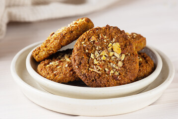 Homemade cookies made from quinoa, nuts, oatmeal and carrots on a light background. Sugar, gluten and lactose free and vegan.
