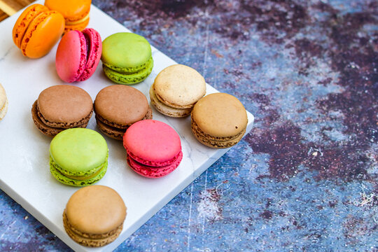 Selection of colorful french macaroons on   industrial background . Patisserie Banner