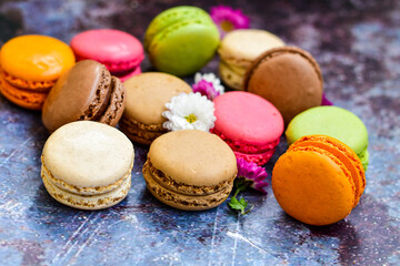 Fototapeta na wymiar Colorful french macaroons on wooden background