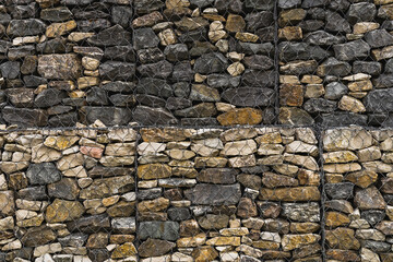 Stone gabions in landscape design as decorative elements in the arrangement of terraces on the site. Wire gabions made of stones protect the walls from collapse in a landscape project.