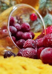 red frozen cherries, red Christmas decorations and a wreath of branches of the Christmas tree