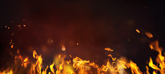  Fire embers particles over black background. Fire sparks background. Abstract dark glitter fire...