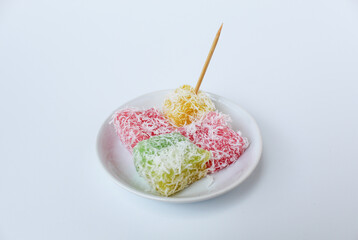 Ongol-ongol, is a traditional snack from Indonesia. Sweet and chewy texture, with coconut sprinkles. Isolated on white background