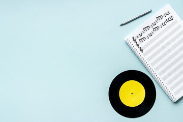 Sheets with music notes and vinyl record. Compose music concept