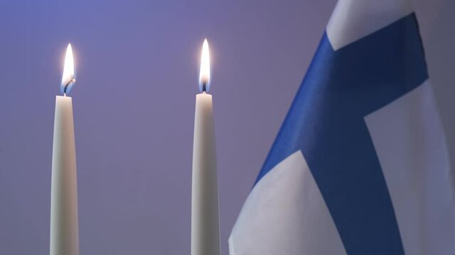 The traditional blue and white candles and flag of Finland