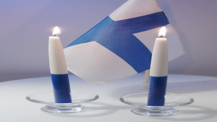 The traditional blue and white candles and flag of Finland
