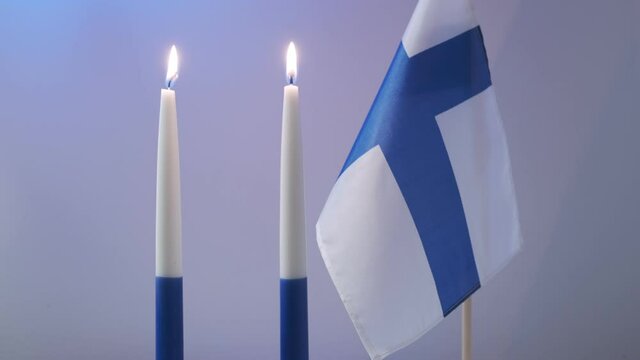 The traditional blue and white candles and flag of Finland