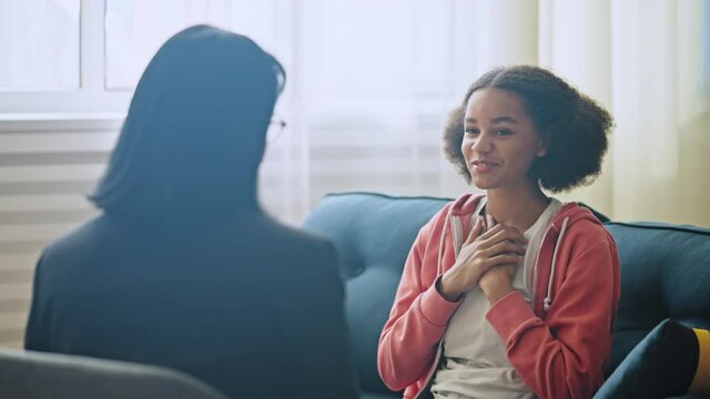 School headmaster praising happy african american girl for good education skills
