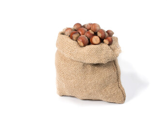 Fresh hazelnuts in a burlap bag, isolated on a white background.