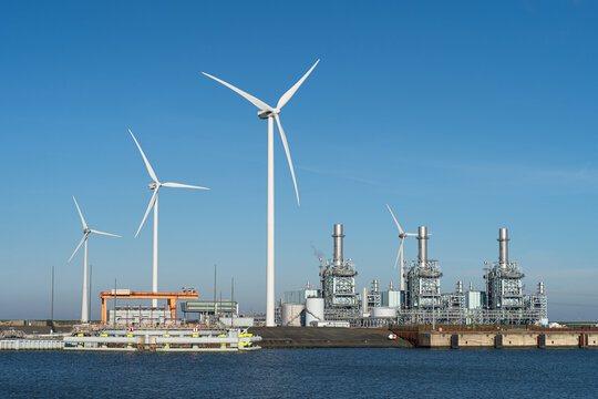 Modern multi-fuel power station and wind turbines at a seaport.