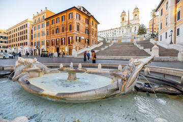 Naklejka premium Cityscape of famous Spanish Steps and Fountain of the Old Boat at sunny morning in Rome. Visiting Famous italian sightseeings, traveling Italy