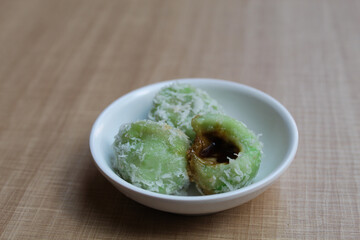 Klepon, is a traditional snack from Indonesia. Made from glutinous rice flour, filled with liquid palm sugar, sprinkled with grated coconut