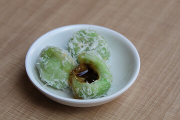 Klepon, is a traditional snack from Indonesia. Made from glutinous rice flour, filled with liquid palm sugar, sprinkled with grated coconut