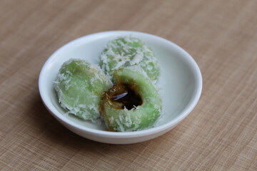 Klepon, is a traditional snack from Indonesia. Made from glutinous rice flour, filled with liquid palm sugar, sprinkled with grated coconut