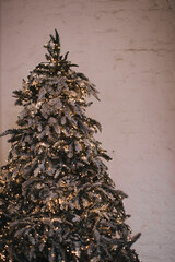 Beautiful indoor interior christmas decorations. Gold Christmas background of de-focused lights with decorated tree