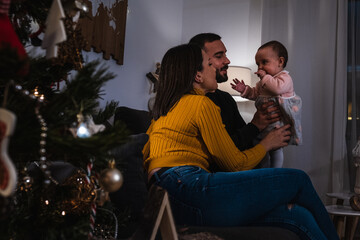 Parents playing with their baby at home