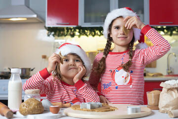 Happy funny kids bake Christmas cookies at home in the kitchen. Merry Christmas for family cooking