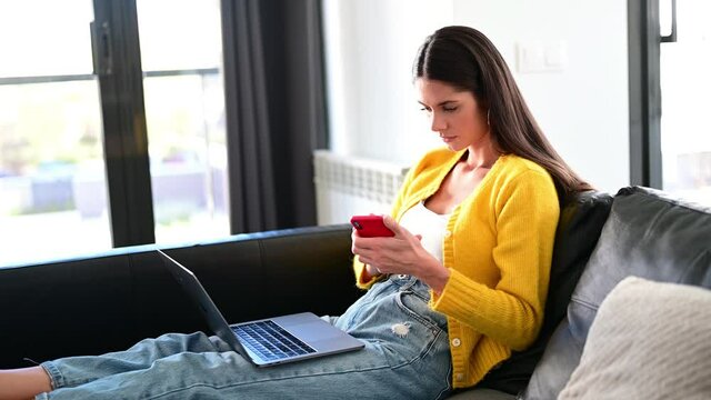Brunette woman teleworking on the couch