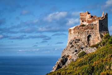 The ancient Torre Vecchia tower overlooking the sea, Gorgona island, Livorno, Italy, on a sunny day