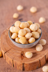 macadamian nuts on dark wooden surface