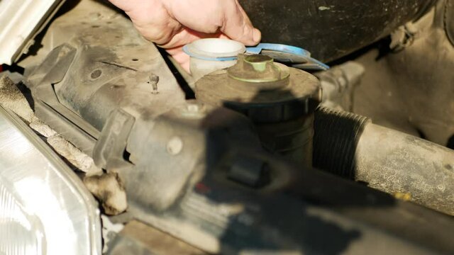 Servicemen Is Adding Antifreeze And Closes The Cap Of The Tank. Close Up View