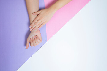 Two woman s hands on white, pink and purple background. Little shine purple star and hart