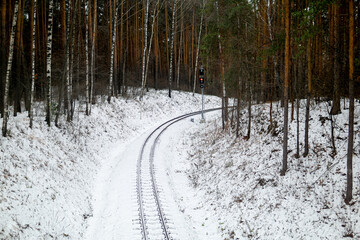narrow gauge railway in winter forest