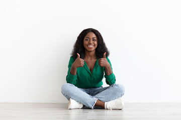 Fototapeta na wymiar Happy african american young woman showing thumb ups