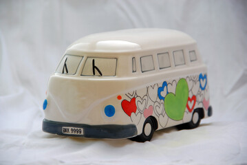Toy van with hearts, symbol of peace and love, on a white background - Powered by Adobe