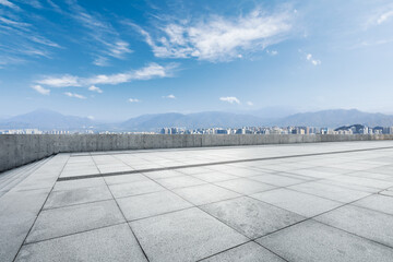 Empty square floor and modern city commercial building with skyline