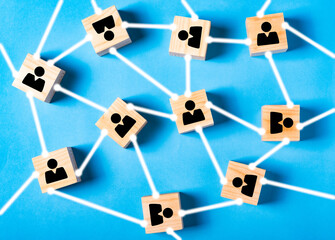 Networking, social media, SNS, internet communication line. Small network connected to a larger network. wooden block with people icon on blue background.