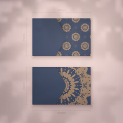 Business card in blue with a luxurious brown pattern for your contacts.