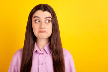 Photo of youth charming woman wondered look empty space unsure puzzled isolated over yellow color background