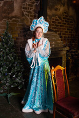 Girl in a Snow Maiden Costume for New Year and Christmas 2022 2021 depicts joy or surprise