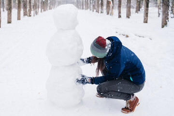 Children play outdoors in snow. Outdoor fun for family Christmas vacation. Two little kid boy and...