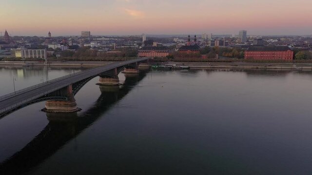 Drone video over the Rhine and Mainz waterfront with Theodor Heuss Bridge in the morning during sunrise