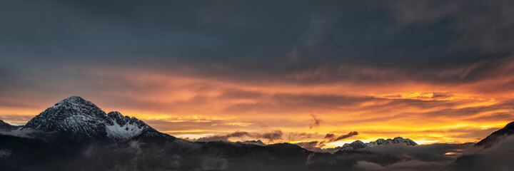 Panorama of mountain range in the evening in Tyrol with dramatic afterglow in autumn