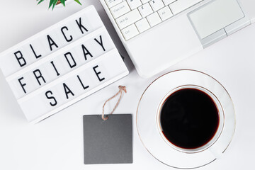 Black Friday concept. Laptop and coffee cup on white background. Online sale
