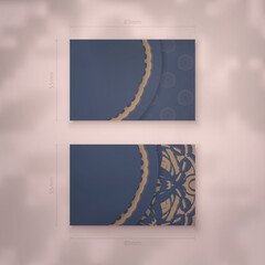 Business card in blue with luxurious brown pattern for your personality.