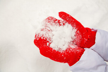 snow on red mittens