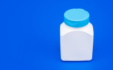 food supplement. presenting vitamin product. white unbranded pill jar.