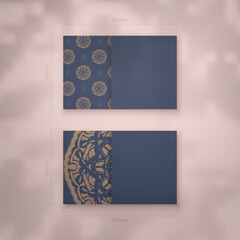Business card in blue with vintage brown ornament for your brand.