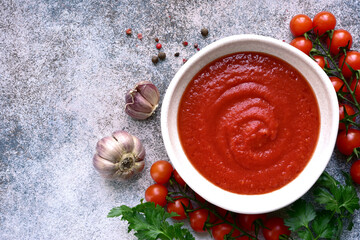 Homemade spicy tomato sauce with ingredients for making . Top view with copy space.